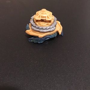 These are two BEYBLADES with a green launcher